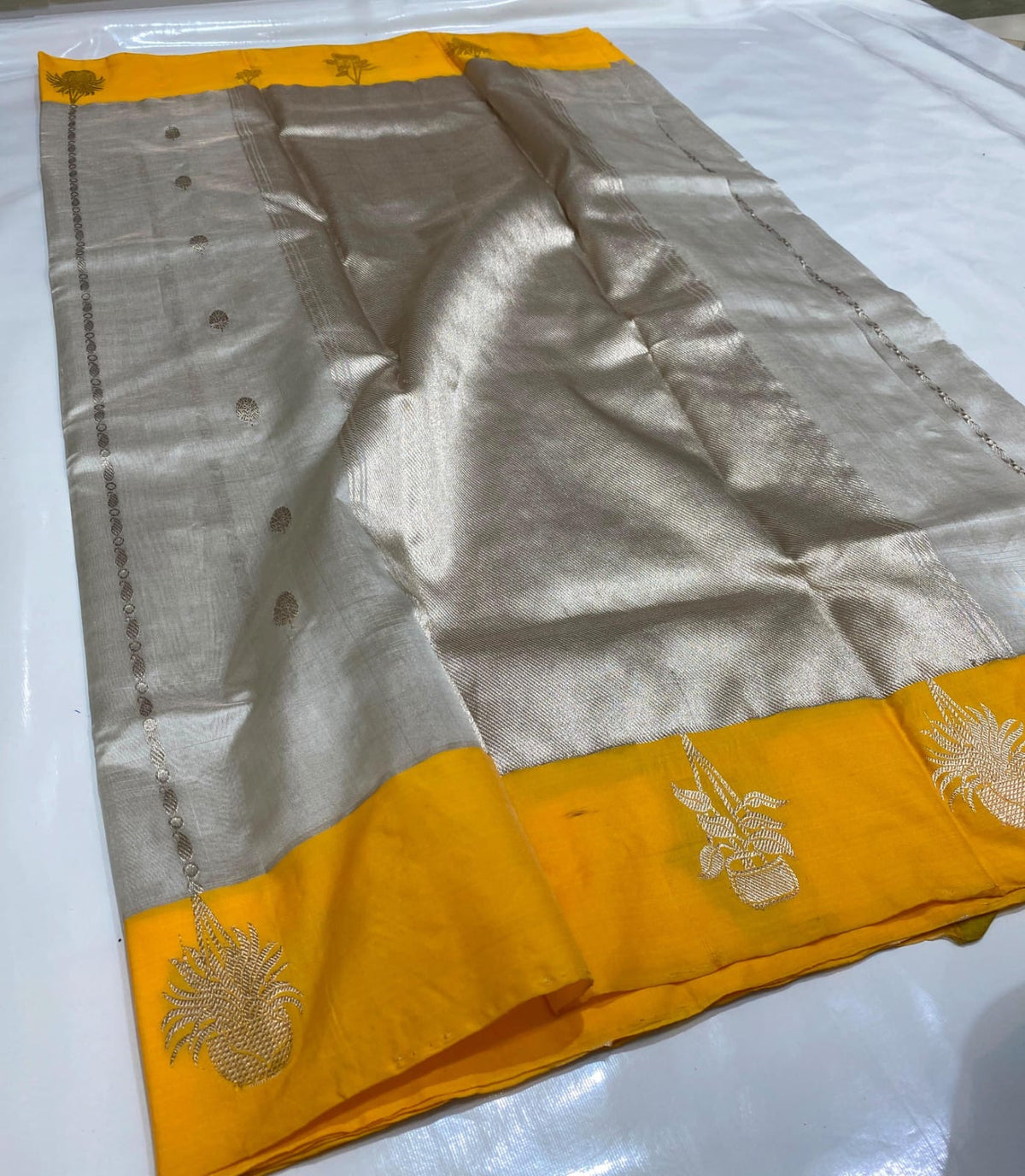 Pearl silver Tissue Pattu Silk Chanderi saree with a marigold yellow border