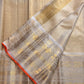 Pale gold handwoven Pure Silk Kanjeevaram Butta saree with orange Meenakari Kamalam motifs and coral-orange selvedge, pallu detail