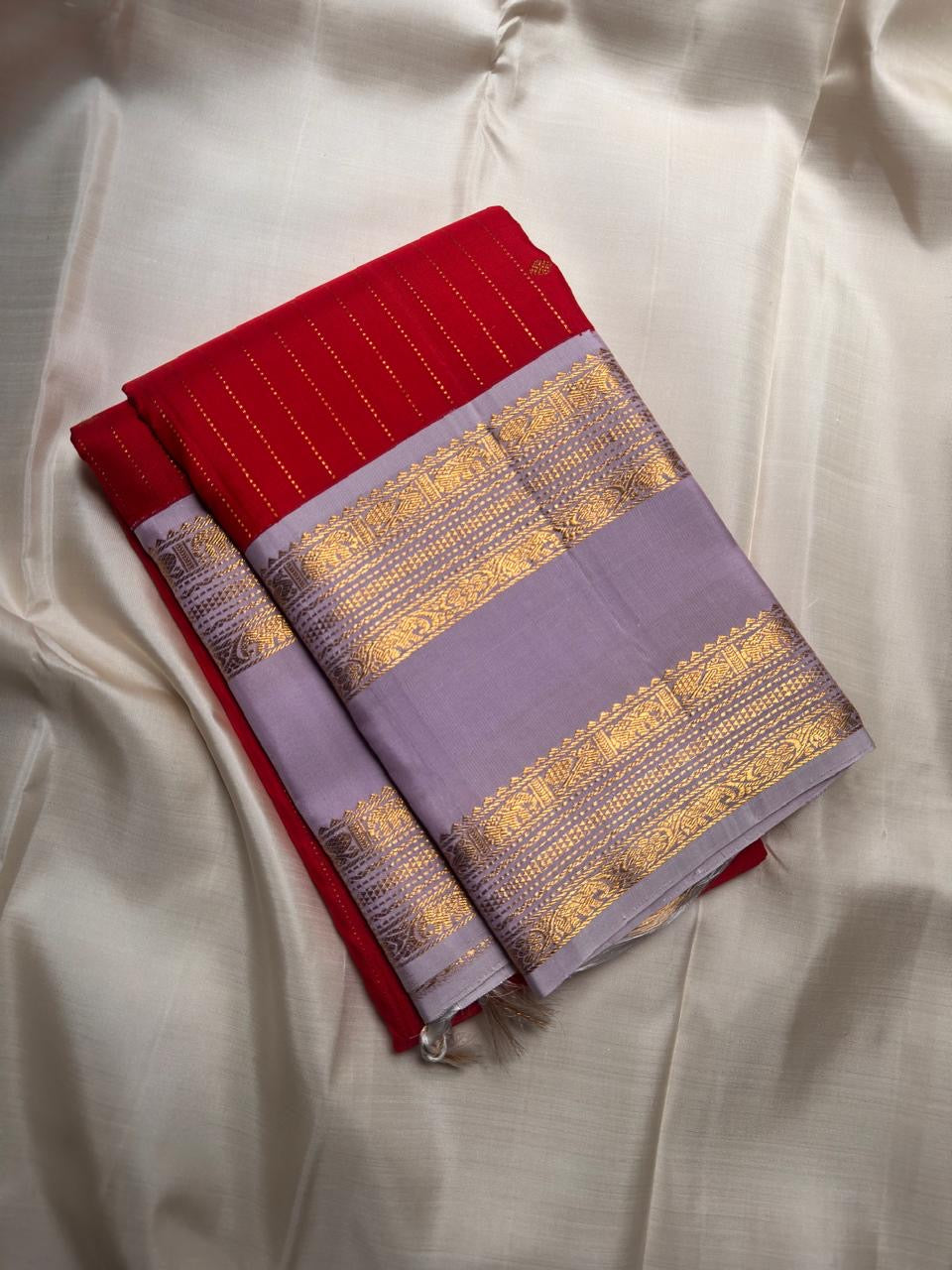 Pale lavender Rettapet zari border on radiant red Kanjeevaram silk saree, border detail