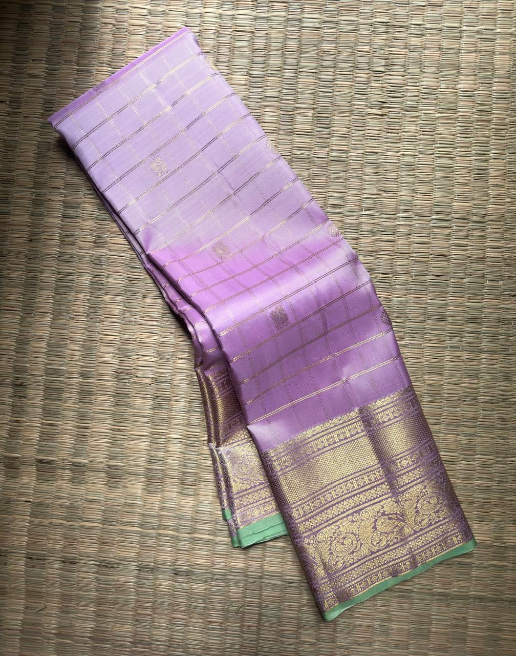 Pale Pink Kanchipuram Zari Kattam saree folded to show Peacock, Vanki Pettu and Benares Pettu border details.