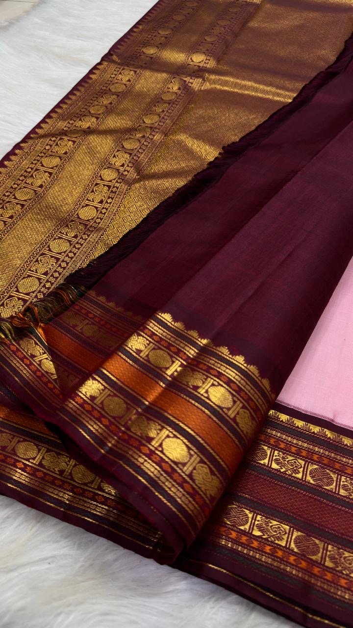 Folded Pale Blush Pink Pure Silk Kanchipuram Korvai saree showing gold zari buttas and deep Aubergine border.