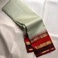 Fine warm-ivory checks woven across the Pale Sage pure silk saree body.