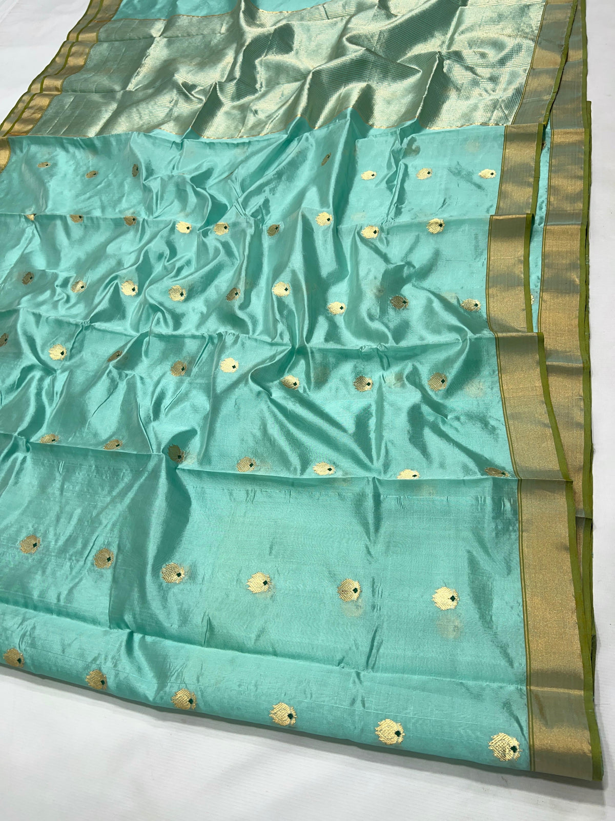 Aqua Blue handloom Katan Silk Chanderi saree draped to show the pale turquoise tone and silk lustre