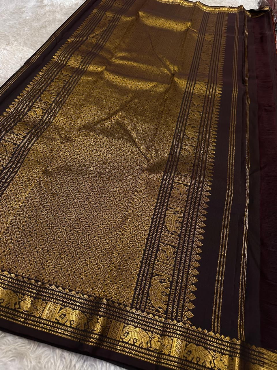 Full pallu layout showing black field with heavy gold zari weave and elephant motif border on Pure Kanchipuram silk saree, available in the USA.