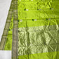 Soft champagne-silver metallic pallu on a parrot green Chanderi handloom saree.