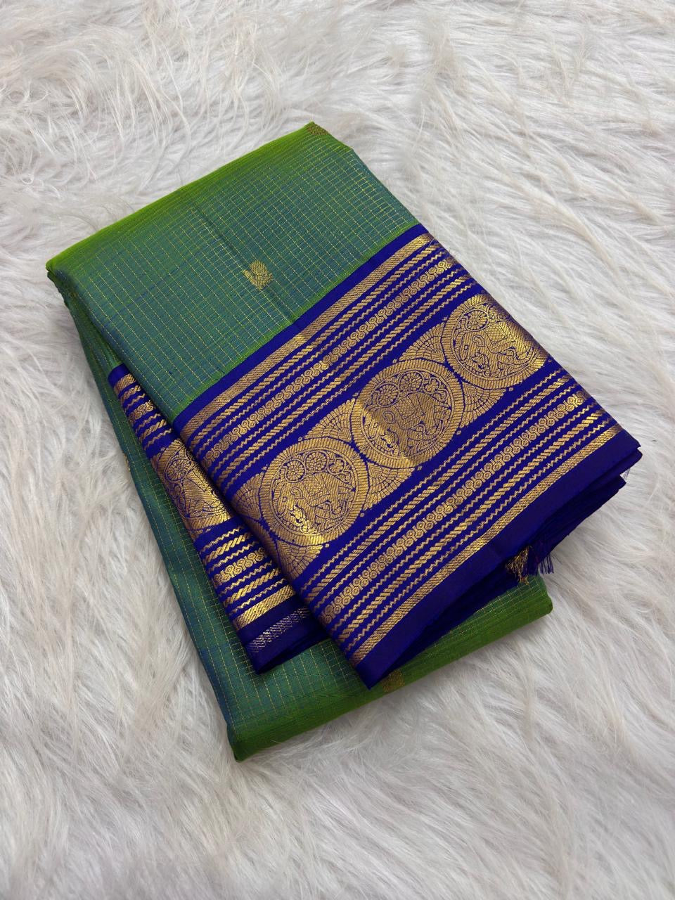 Close-up of Sorgavaasal Mayil peacocks within arched frames on the royal blue zari border