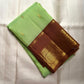 Parrot Green Kanjivaram silk saree with Deep Kaapi Brown contrast border and gold Poo Buttas