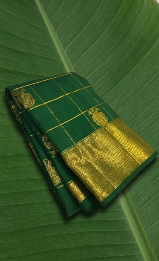 Jewel-toned parrot green Kanchipuram silk saree with zari kattam checks and woven Gandaberunda motifs in traditional zari