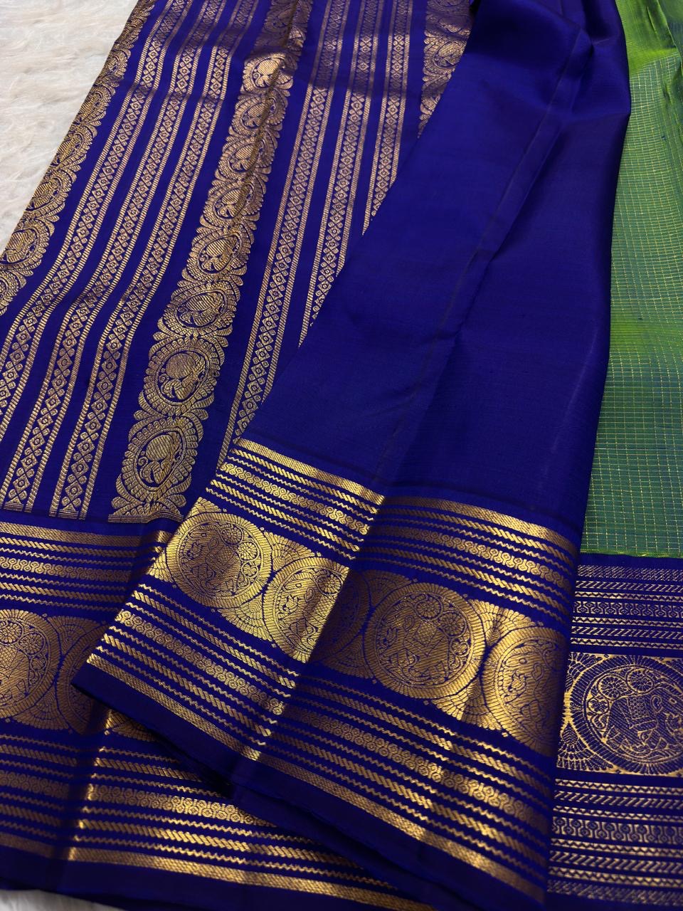 Parrot green silk body meeting the royal blue and gold zari border