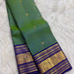 Full view of a parrot green Kanchipuram Zari Kattam silk saree with a royal blue Sorgavaasal Mayil zari border