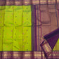 Parrot Green Kanchipuram Korvai saree showing Rani Pink and Orange silk-thread buttas with detailed gold Mayil border.