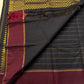 Flat-lay of Pure Kanchipuram Silk Saree highlighting the checked black body with maroon zari border panel and border band
