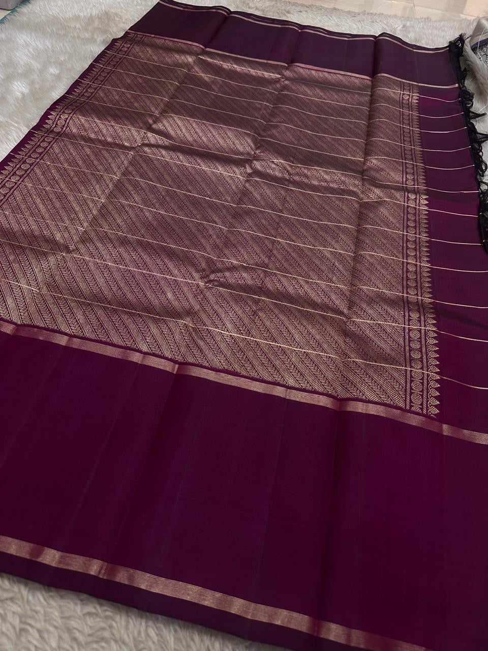 Wide pallu spread of plum Pure Kanchipuram silk saree featuring an expansive zari-woven pallu panel and contrast border, available in the USA.