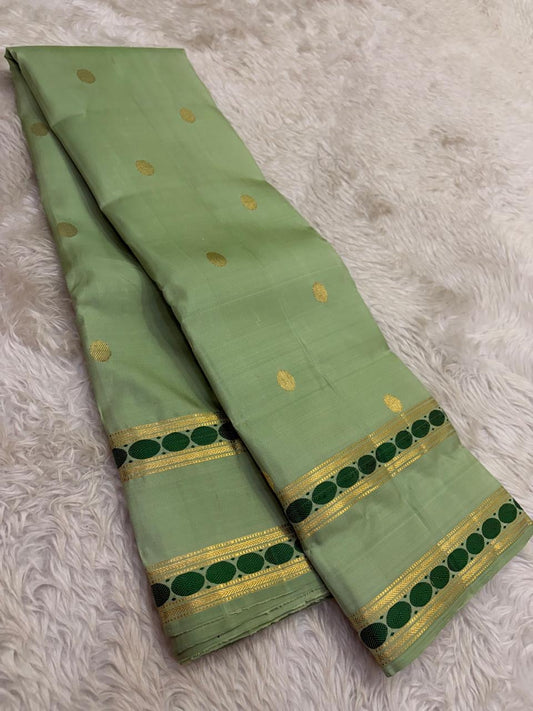 Pastel sage green Kanjeevaram silk saree body with zari pavun buttas
