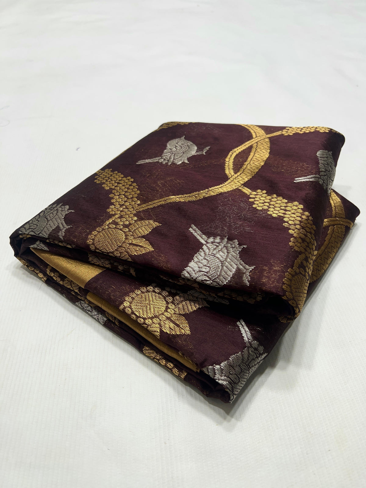 Deep Cocoa Brown Pattu Silk Chanderi saree pallu showing the broad antique-gold woven field with Cocoa Brown end panel.