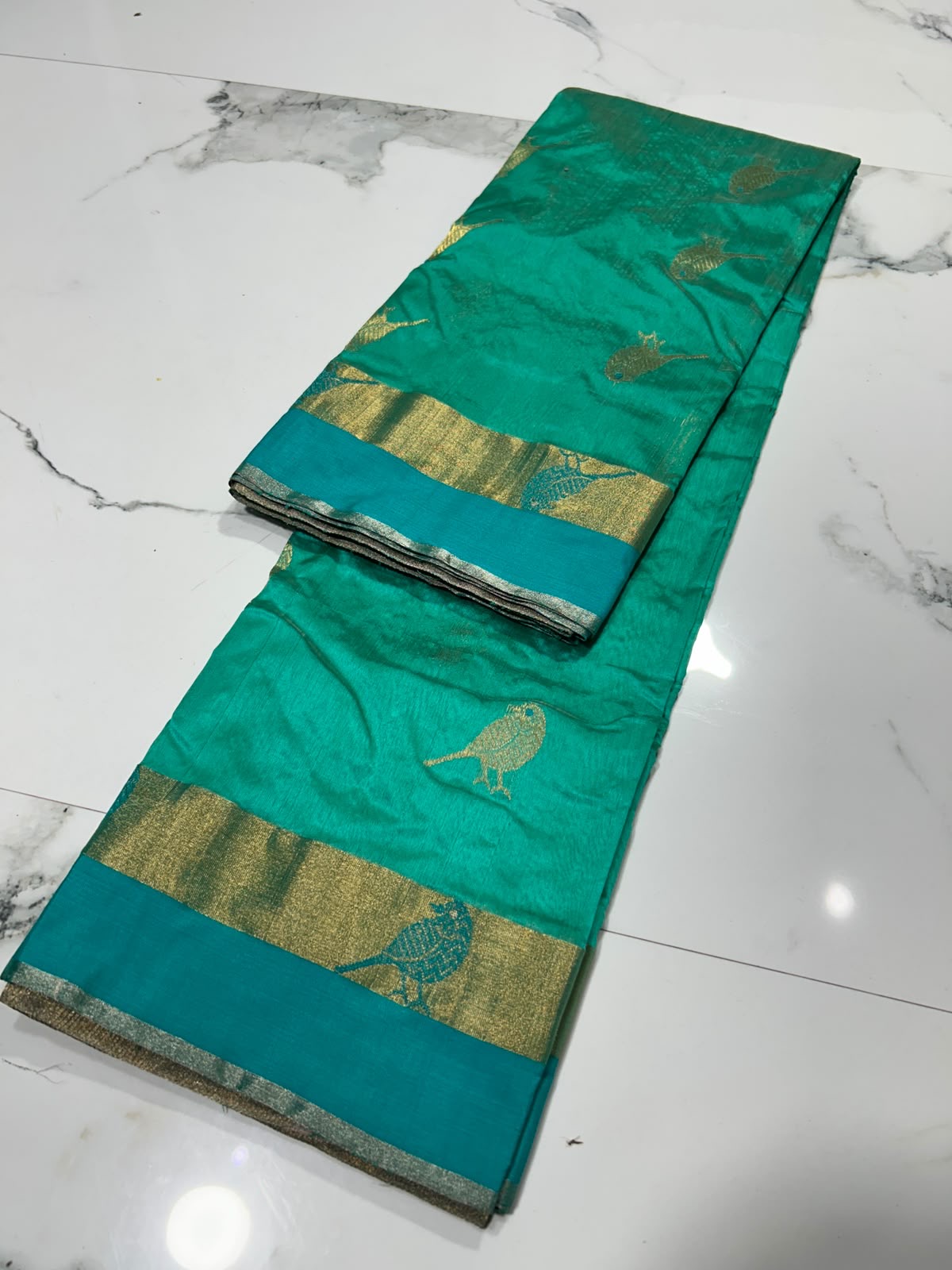 Turquoise Green Pattu Silk Chanderi saree body detail with repeated gold woven bird motifs