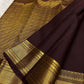 Close detail of small Pavun zari buttas aligned across deep brown handwoven Kanjivaram silk