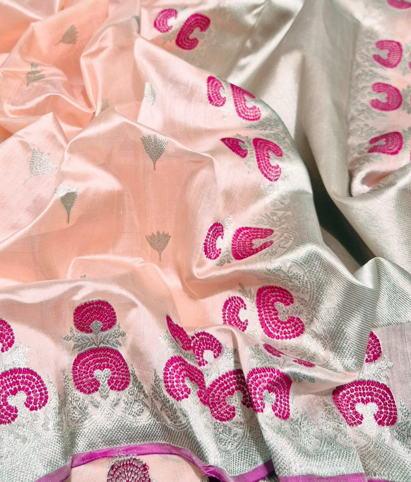 Close view of Peach Blush Chanderi silk saree with small metallic buttas and magenta woven border motifs
