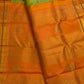 Peach-gold Vanasringaram border with layered Vanki Pet zari work on an ilampachai green Kanchipuram saree.