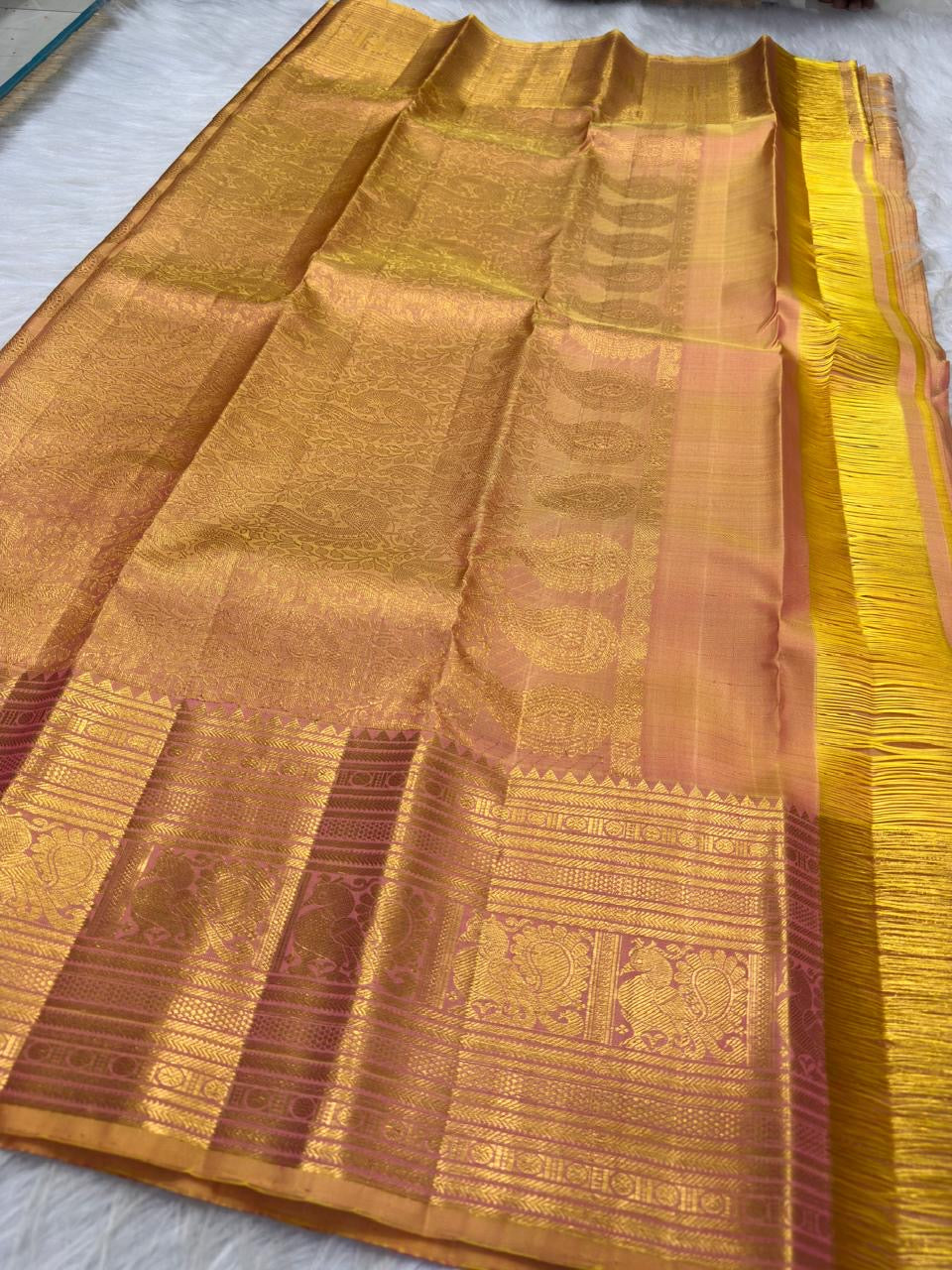 Peach Gold pure mulberry silk saree with delicate zari lines and traditional gold buttas.