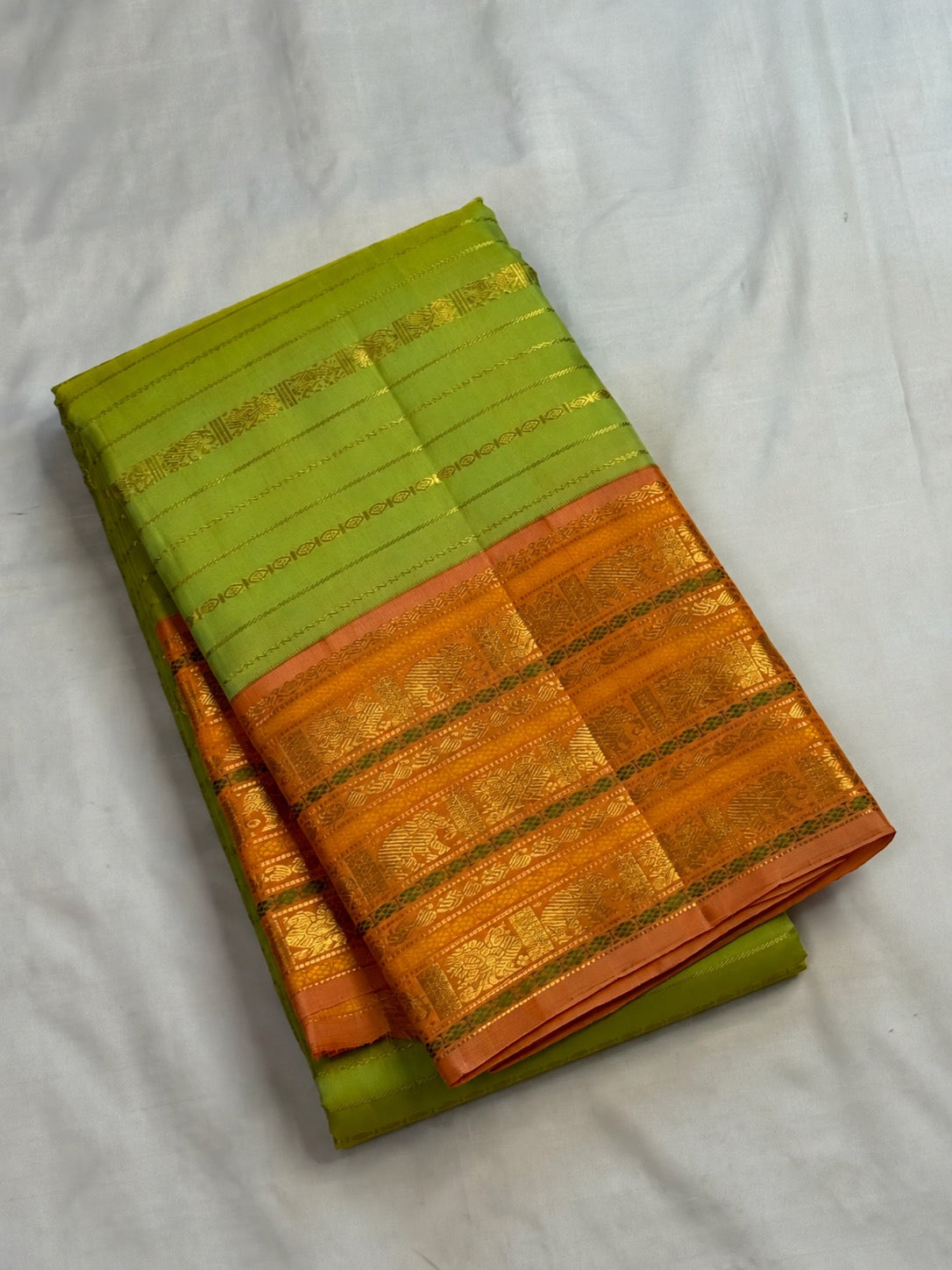 Dense zari pallu with Vanasringaram, Yaanai and Mayil motifs on a soft green Kanchipuram Vairaoosi saree.