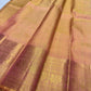 Close view of small gold zari buttas woven across luminous peach gold pure silk saree.