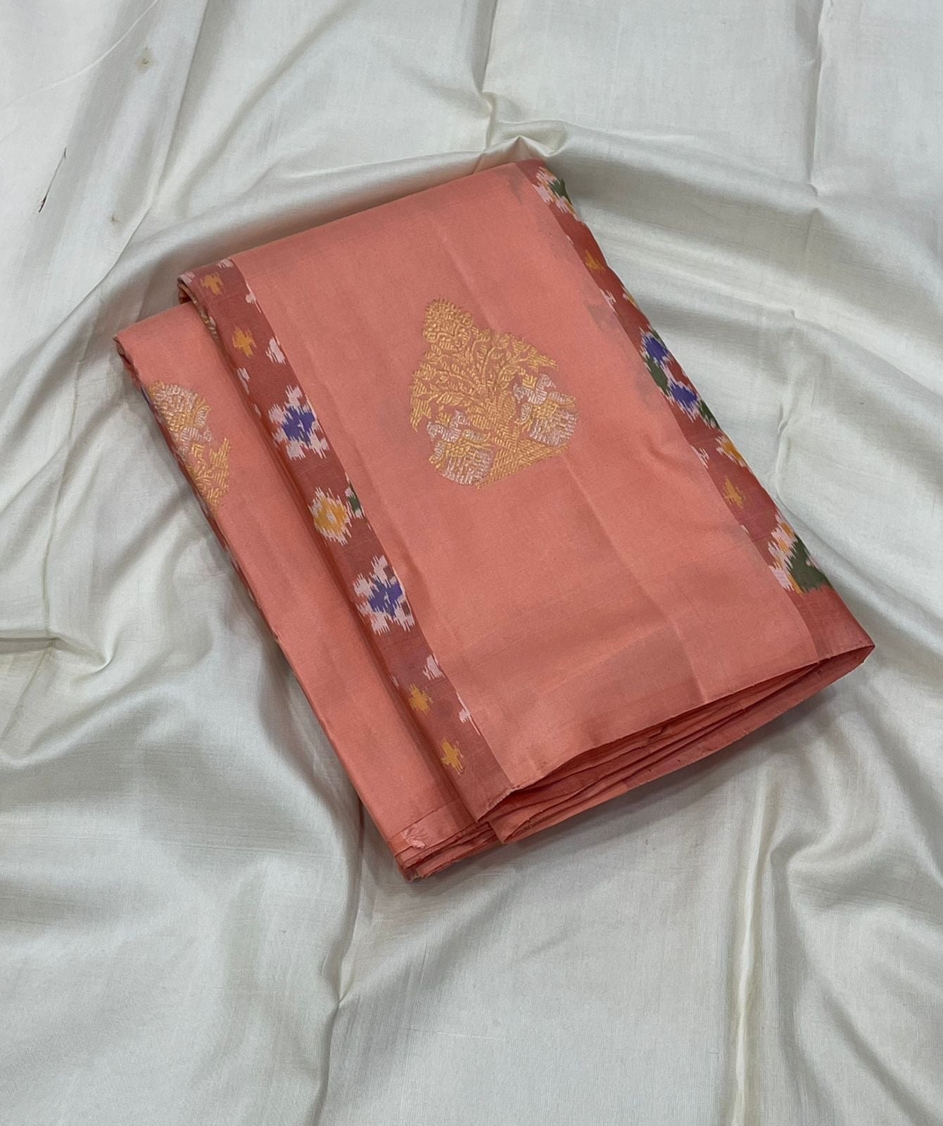 Pochampally ikat weave detail on peach pink border of peach Kanjeevaram silk saree — Idam Living