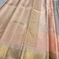 Handwoven peach pink and grey Kanjivaram saree with broad antique-gold paisley border.