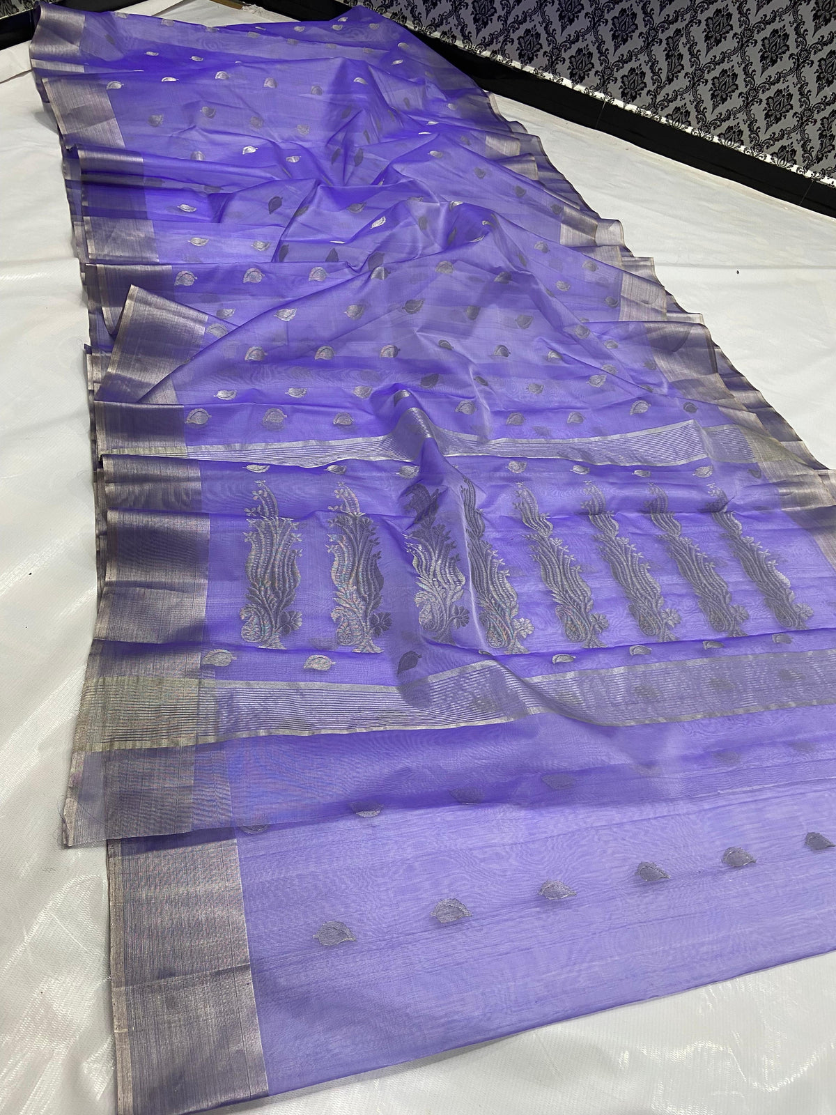 Amethyst lavender Pattu silk Chanderi saree draped to show paisley buttas, silver-grey border and pallu