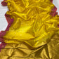 Turmeric yellow Chanderi Pattu silk saree draped to show its luminous body and raspberry pink border