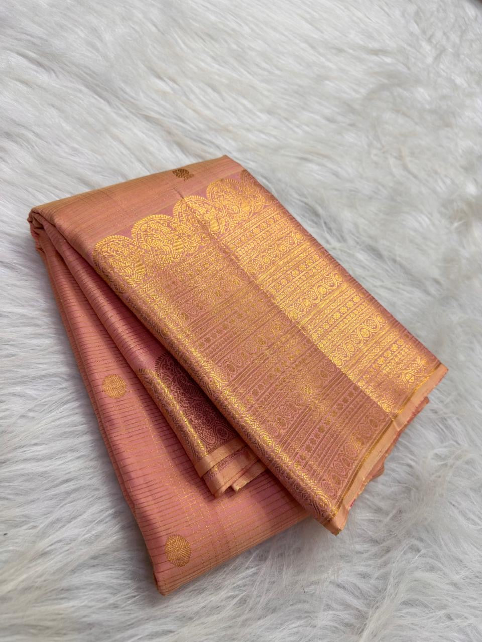 Soft Peach Blush Kanchipuram Zari Kattam saree showing petite gold buttas and broad traditional zari border.
