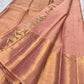 Folded Soft Peach Blush Pure Silk Kanchipuram Zari Kattam saree with gold buttas and ornate tonal zari border.