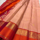 Soft peach pink Kanjipuram saree, paisley zari border close-up