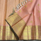Peach pink and classic-gold Kanchipuram silk showing fine grid work, ornate border and dense pallu weaving.