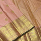 Soft peach-pink Kanchipuram body showing a fine classic-gold Zari Kattam grid beneath spaced zari buttas.