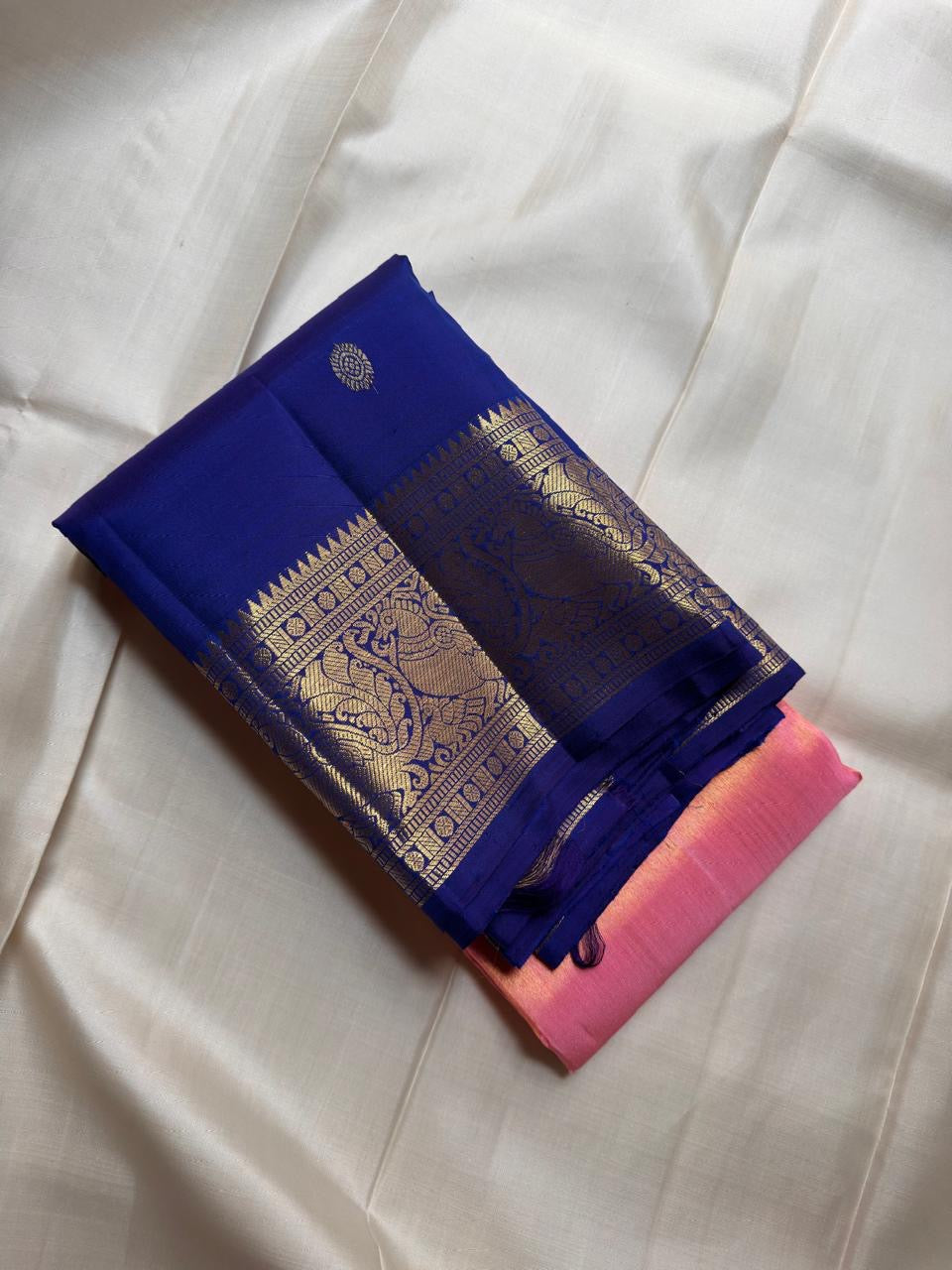 Peach pink tissue Kanchipuram Butta saree with blue elephant border