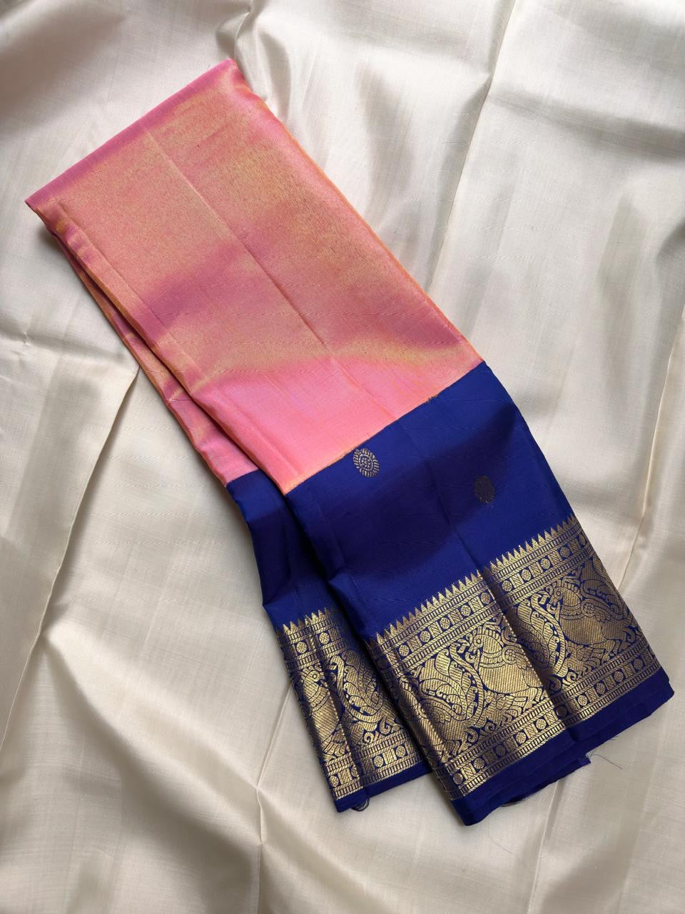 Peach pink tissue Kanjeevaram Butta saree with royal blue Yaanai zari border