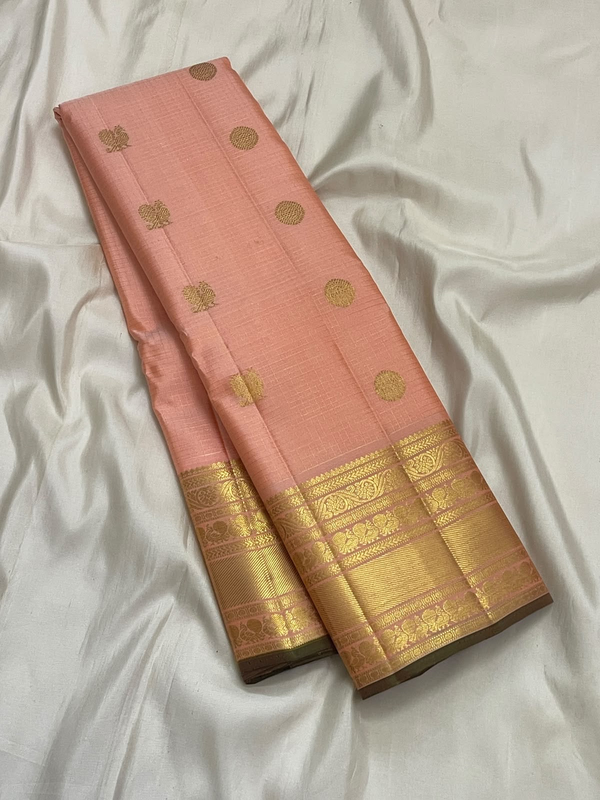 Peach-pink Pure Silk Kanchipuram Zari Kattam saree with a fine gold grid and layered classic-gold border.