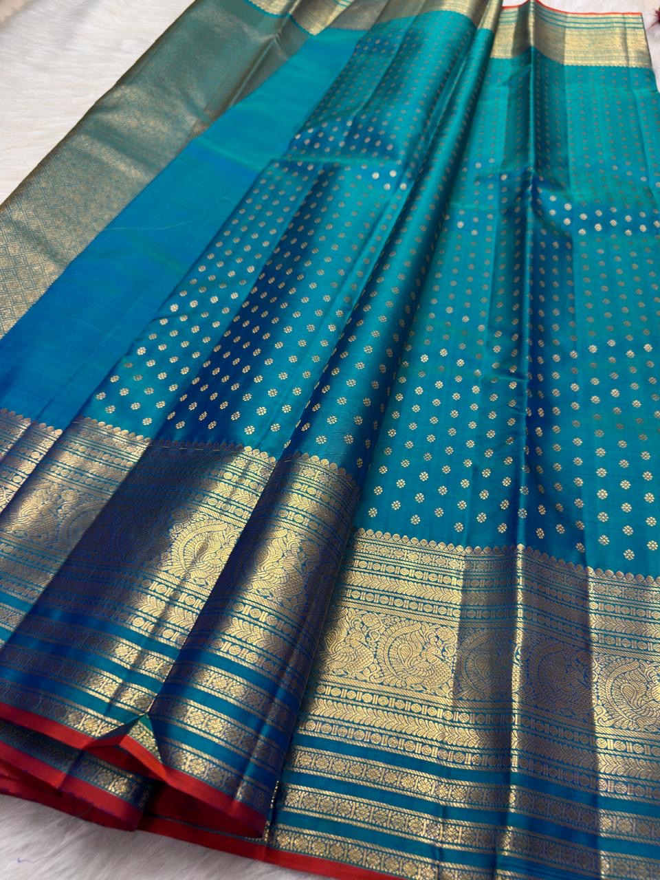 Deep Sapphire Blue Kanchipuram Butta saree with rich gold border and narrow Red selvedge.