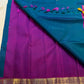 Pallu detail showing magenta ground with gold zari edge, peacock blue Kancheepuram saree
