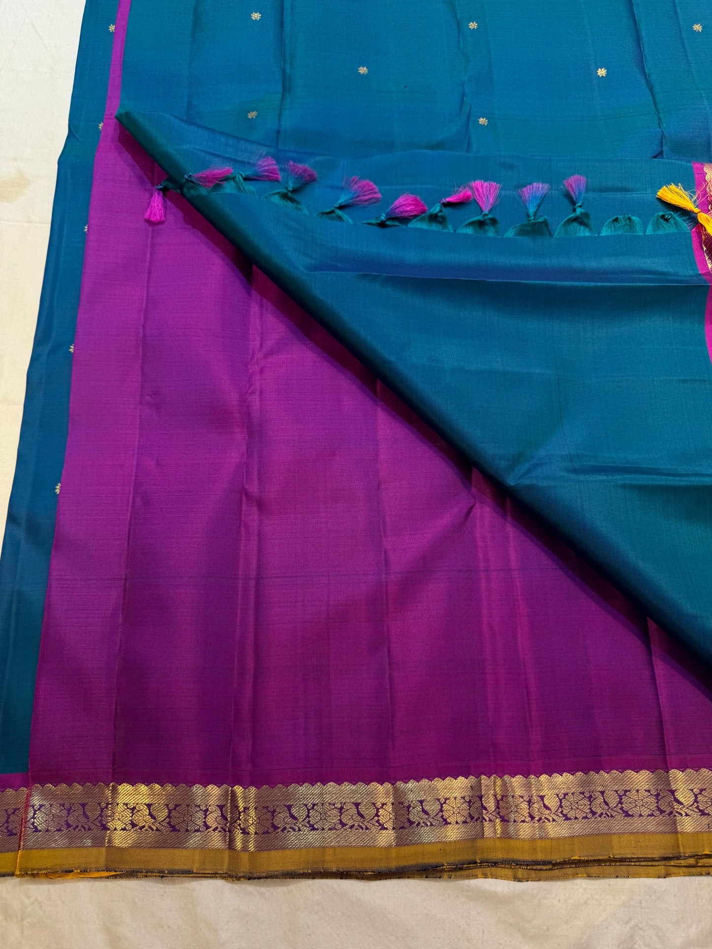 Pallu detail showing magenta ground with gold zari edge, peacock blue Kancheepuram saree
