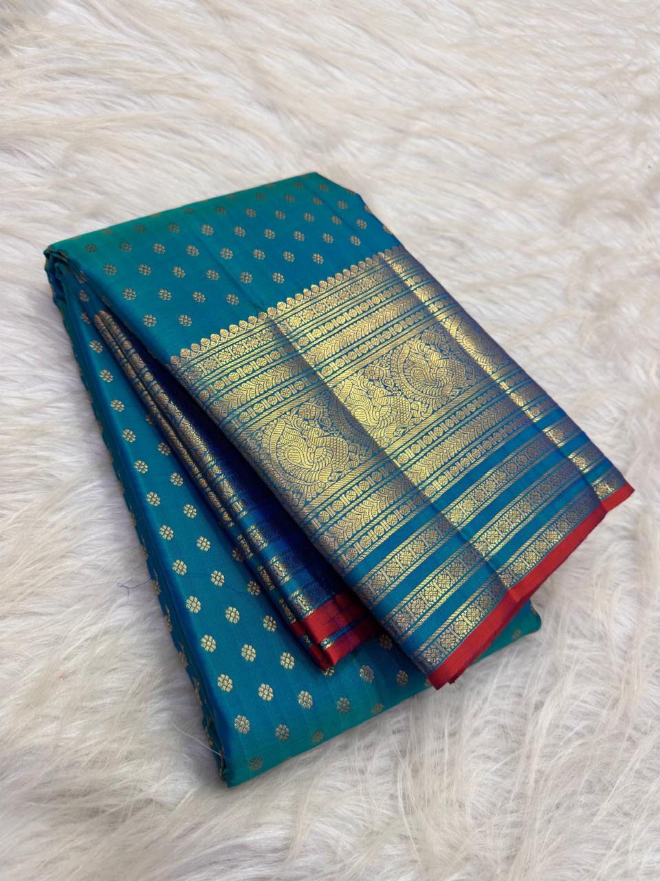 Sapphire Blue pure silk Kanchipuram Butta saree with antique-gold zari border and Red selvedge.