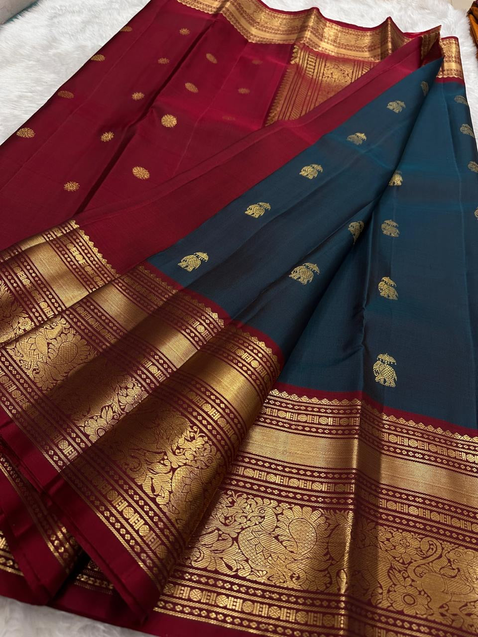 Deep red Vanasringaram gold zari border of peacock blue Kanjeevaram pure silk saree with elephant procession motif