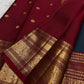 Folded peacock blue Kanjeevaram pure silk saree showing shot colour body with Yaanai Ambari Butta and deep red border