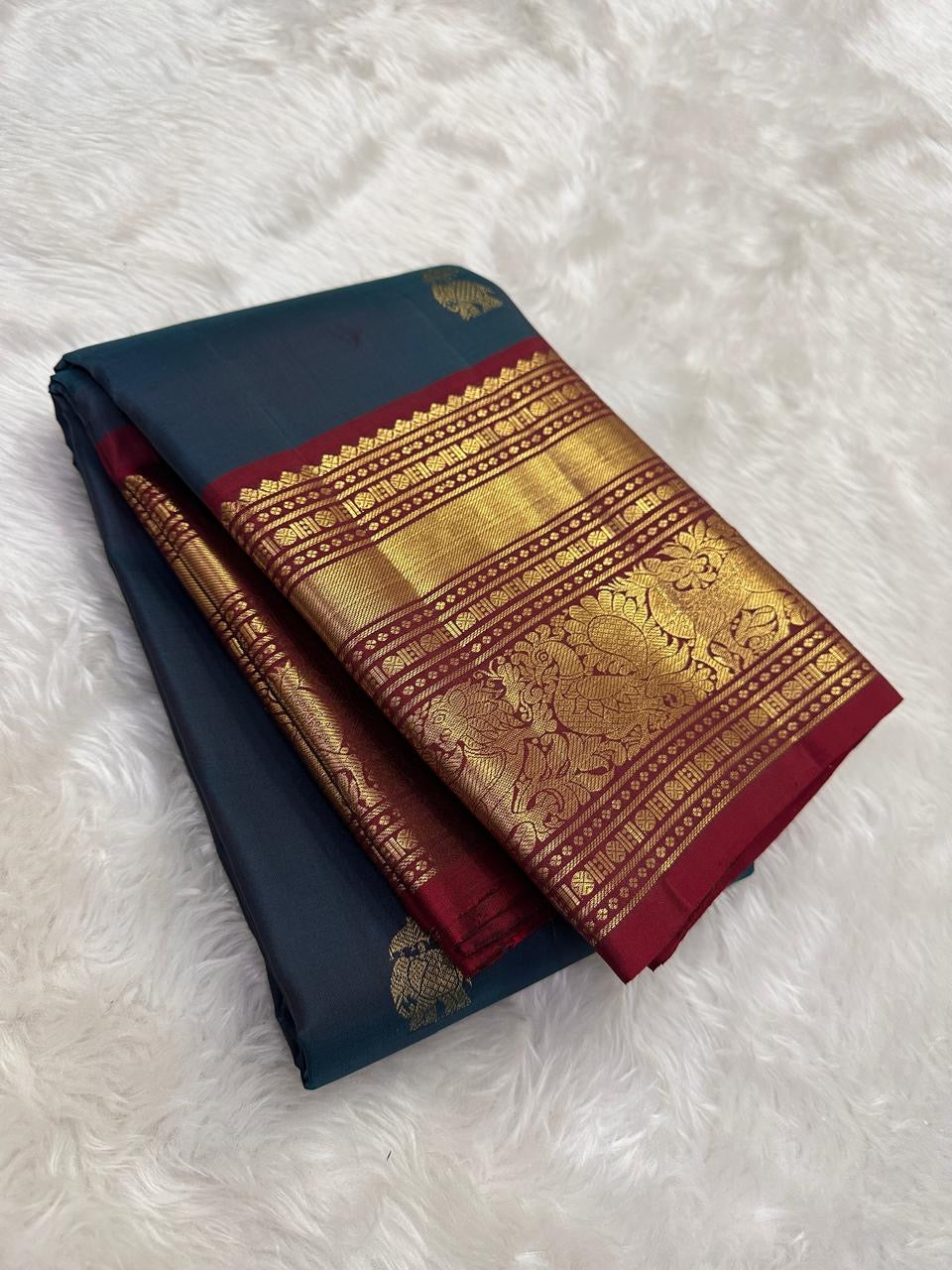 Close view of shot colour peacock blue-green Kanjeevaram silk body with ornate gold zari Yaanai Ambari Butta