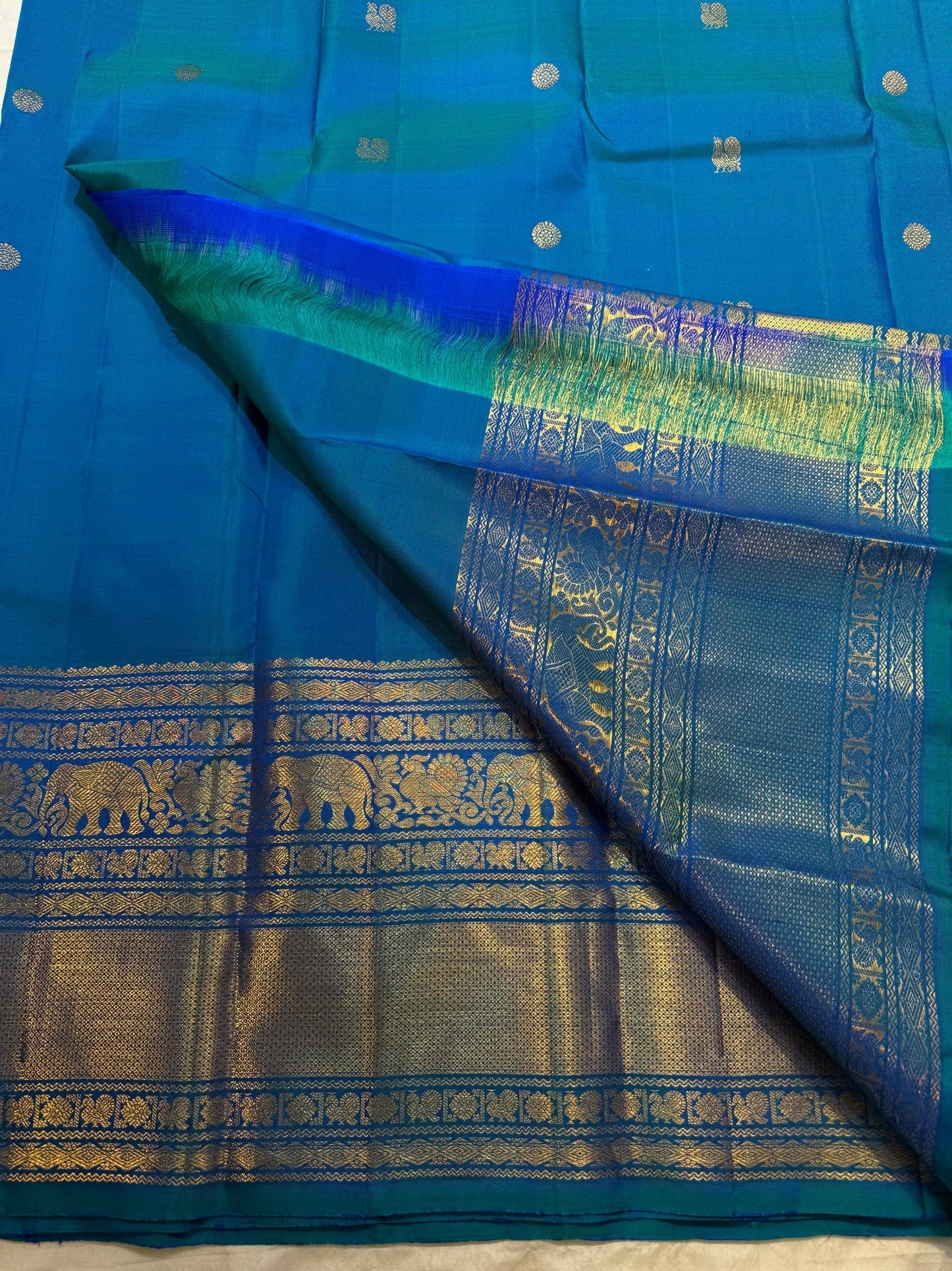 Peacock Blue silk saree with elephant zari Varisaipet border detail.
