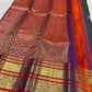 Gold zari floral and Banarasi-inspired decorative motifs across the traditional Kanchipuram contrast border.