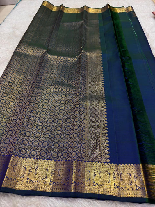 Blue-green handwoven pure silk saree with traditional paisley buttas and peacock zari border