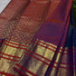 Handwoven Chen buttas spaced across the striped silk body of the peacock blue green Vairaoosi saree.
