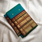 Peacock Blue-Green Pure Silk Kanchipuram Varisaipet saree with petite gold buttas and intricate stacked zari border.
